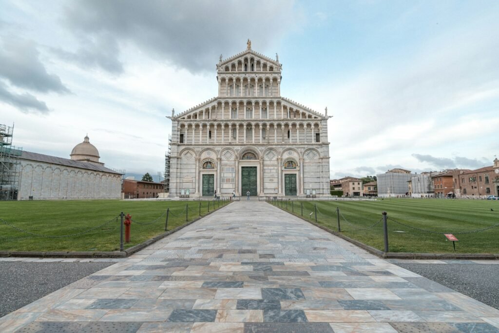white concrete building under white clouds during daytime