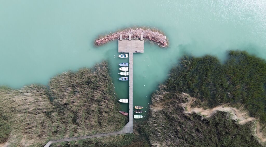 an aerial view of a pier with boats in the water